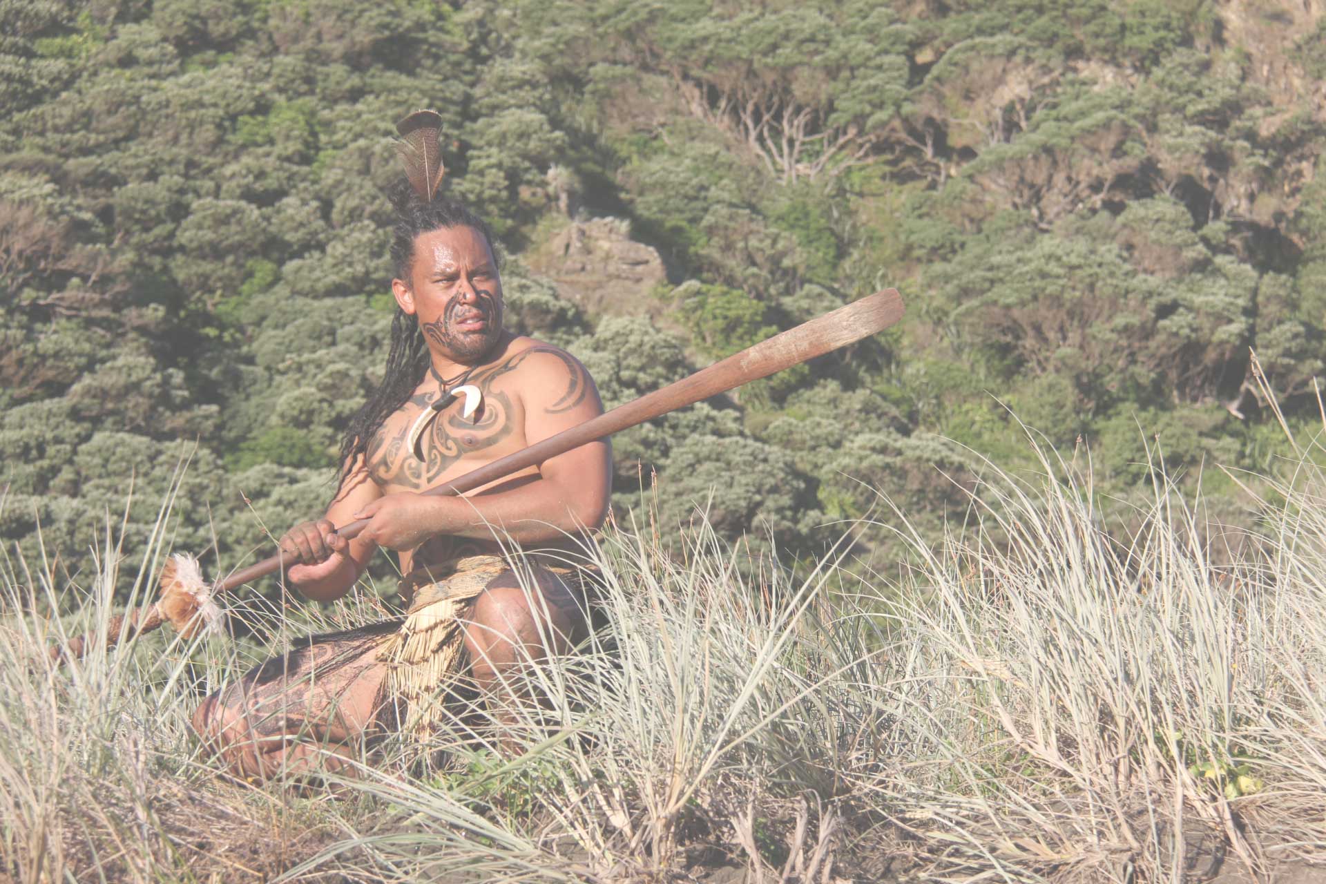 kapa-haka-maori-warrior-with-taiaha-on-beach kapa haka maori warrior with taiaha on beach