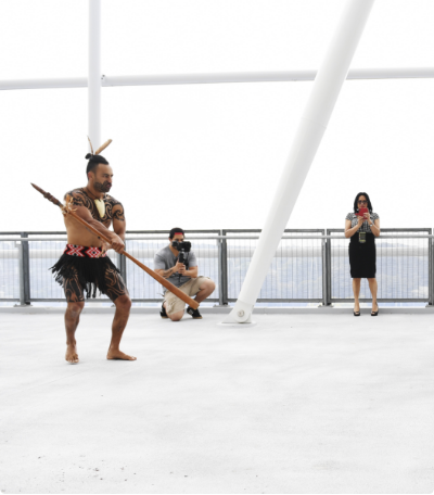 A Māori warrior lays down the rau for the guests to pick up during a haka powhiri, performed at Mt Eden Park by The Haka Experience